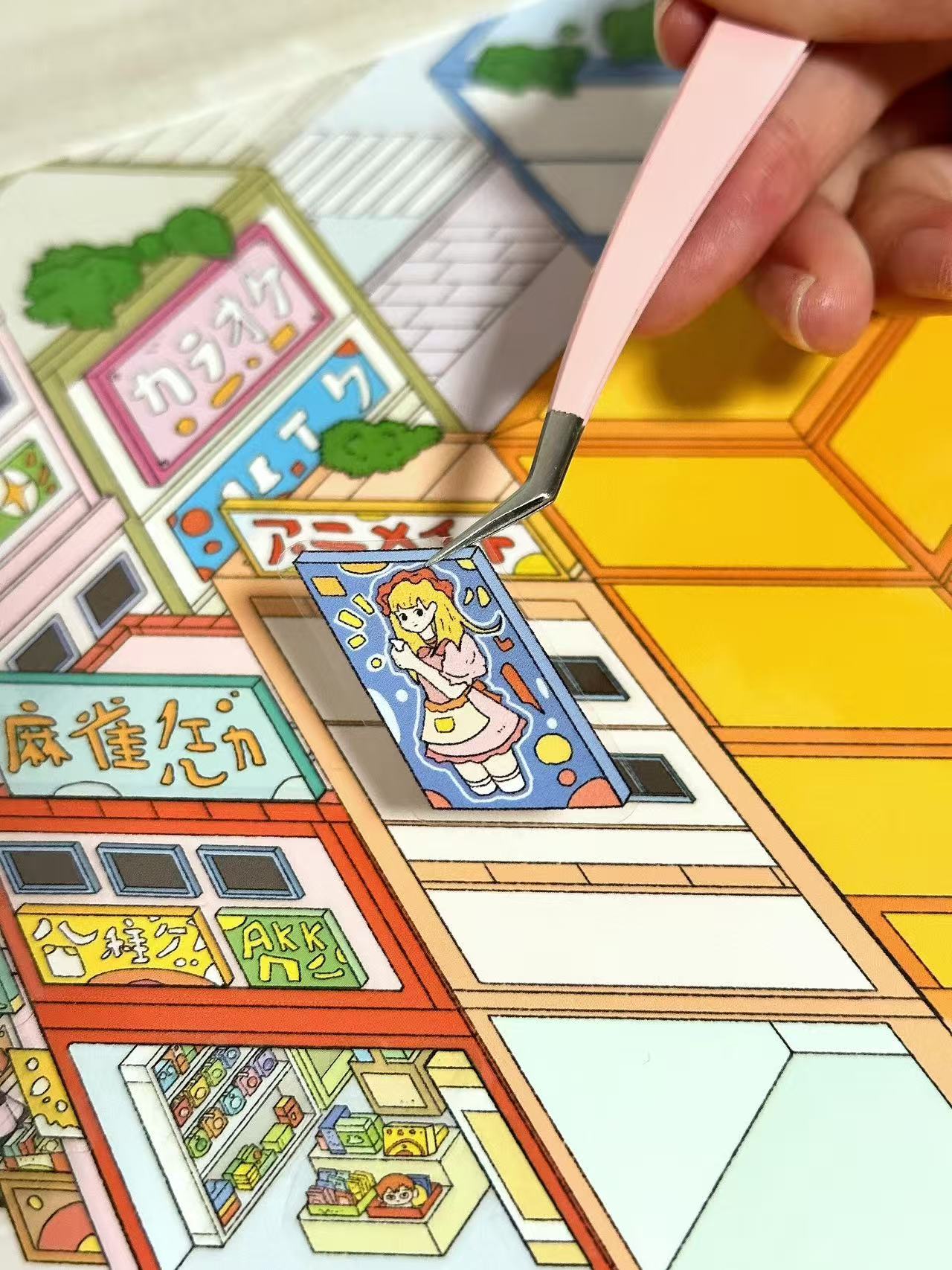 Colorful card game with character illustration and Japanese text, being held by a hand.