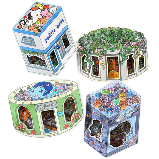 Four colorful paper models of different themed rooms on a white background