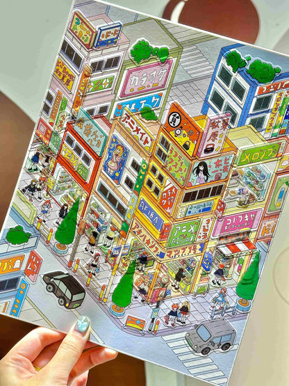 Colorful illustration of a city street scene on a paper, held by a hand.