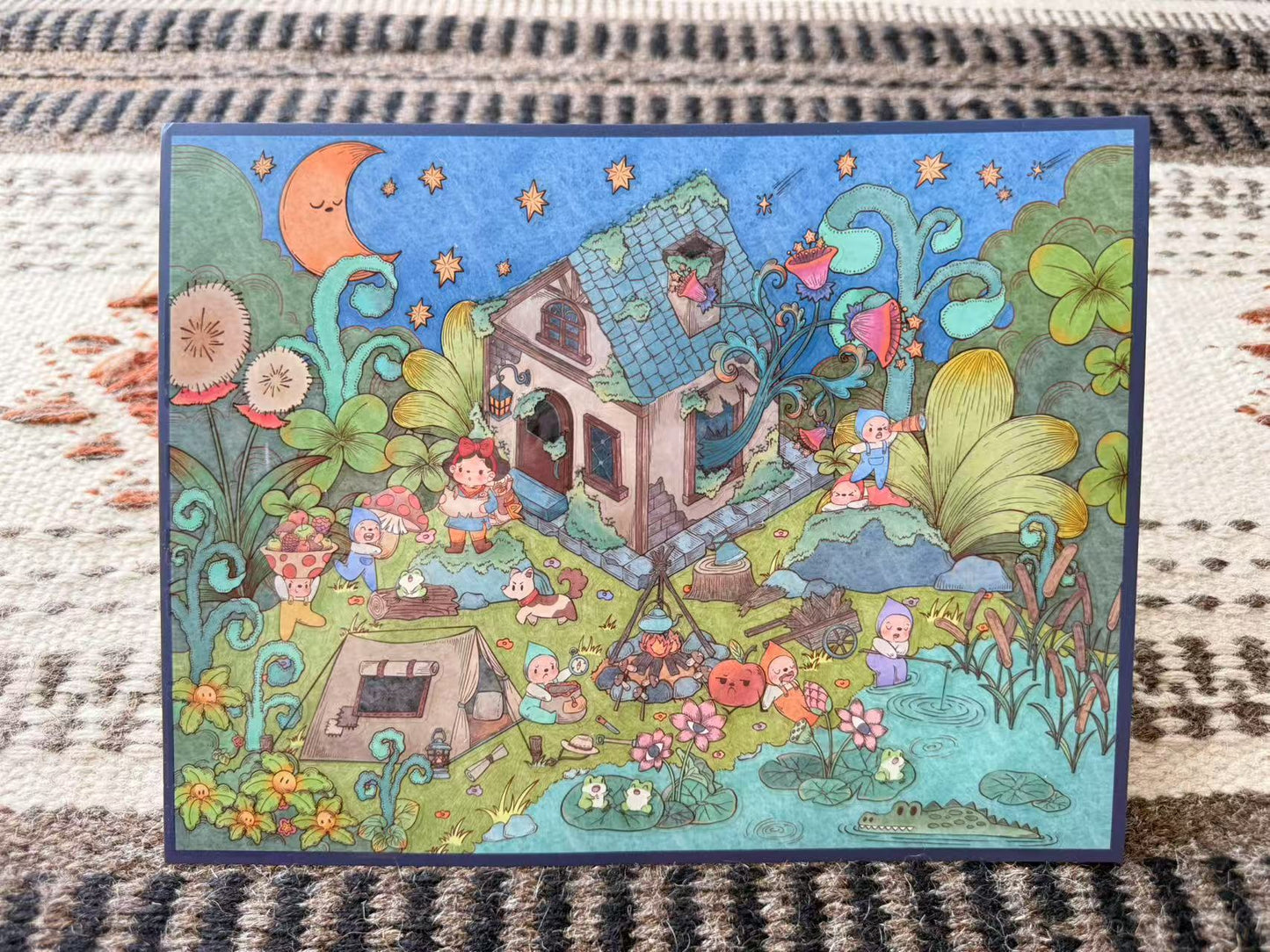 Colorful illustration of a fairy tale scene with houses, trees, and characters on a textured fabric background.