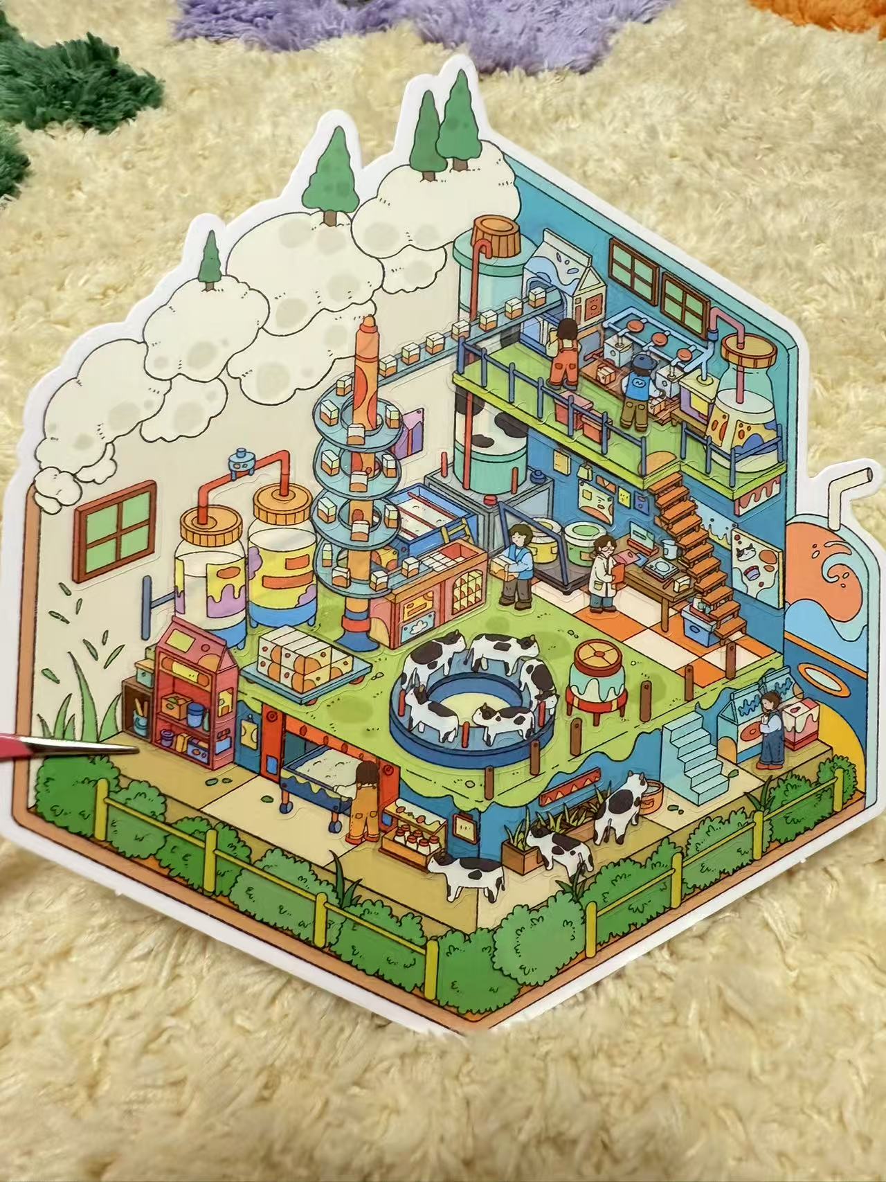 Colorful illustrated miniature cityscape with various buildings and activities on a textured surface.